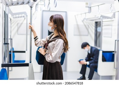 A High School Girl Wearing A Mask On The Train