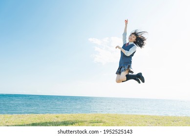 High School Girls Jumping In The Blue Sky