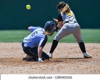 High School Girls Making Plays During A Softball Game