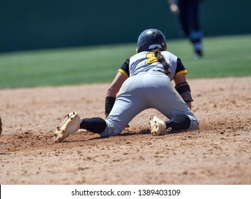 High School Girls Making Plays During A Softball Game