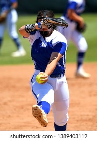 High School Girls Making Plays During A Softball Game