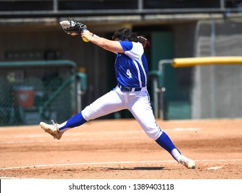 High School Girls Making Plays During A Softball Game