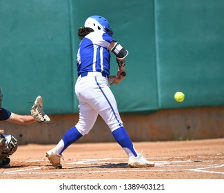 High School Girls Making Plays During A Softball Game