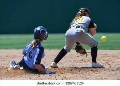 High School Girls making plays during a softball game - Powered by Shutterstock