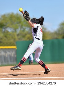 High School Girls Playing In A Softball Game