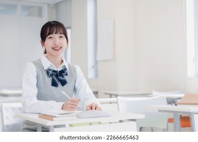 High school girls studying by themselves in a classroom - Powered by Shutterstock