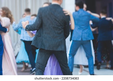 High school graduates dancing waltz and classical ball dance in dresses and suits on school prom graduation, classical ballroom dancers dancing, waltz, quadrille and polonaise - Shutterstock ID 2208734083