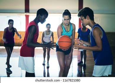 High School Kids About To Start Playing Basketball In The Court