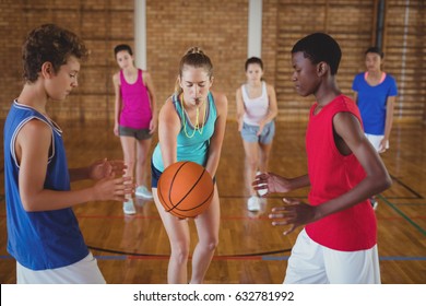 High School Kids About To Start Playing Basketball In The Court