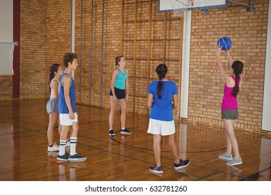 High School Kids Playing Basketball In The Court