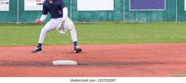 High School Second Baseman Backhands A Ground Ball Into His White Baseball Glove Making The Play During A Game.