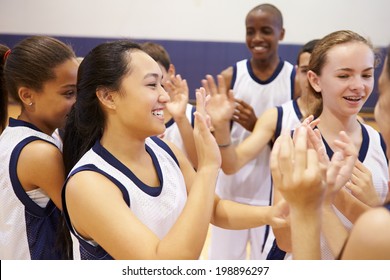 High School Sports Team Celebrating In Gym