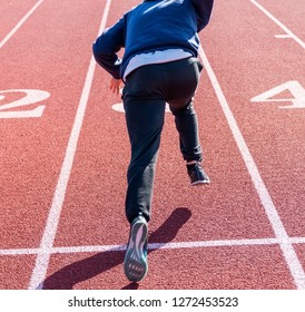 A High School Sprinter Is Practiceng His Running Starts On A Track At Track And Field Practice.