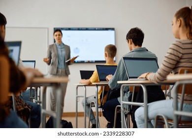 High school student and his classmates learning computer coding on a laptops in the classroom. - Powered by Shutterstock