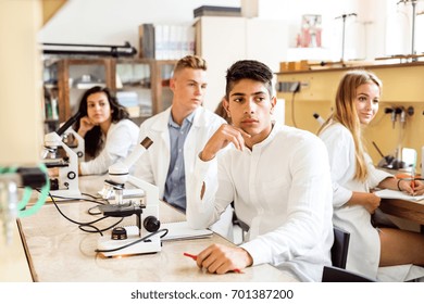 High School Student With Microscopes In Laboratory.