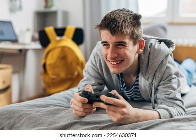 High school student plays video games after school - Shutterstock ID 2254630371