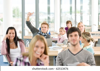 High School Student Raising Hands In Classroom