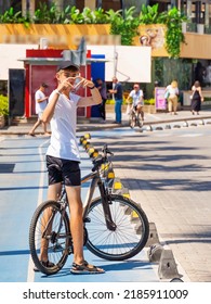 High School Student, Teenager On The Way To School Or Home From School Rides A Bike. Vertical.