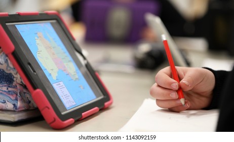 High School Student Using Electronic Device Tablet Style Computer Research Learning Knowledge. Theme Of Classroom Teaching Teacher Pedagogy Educate And Education  Modern Contemporary Learning Tools.