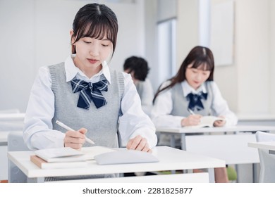 High school students concentrating and taking notes - Shutterstock ID 2281825877