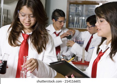 High School Students Conducting Experiment