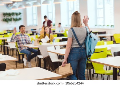 High School Students Greeting Their Classmate At School Cafeteria