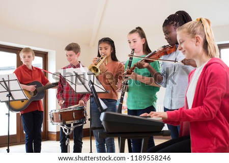 High School Students Playing In School Orchestra Together