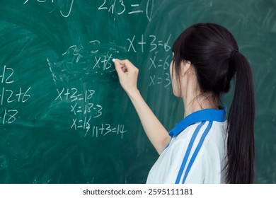 High school students solving math problems on the blackboard in classroom during class