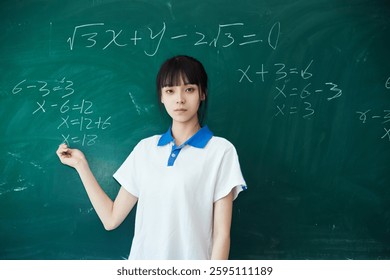 High school students solving math problems on the blackboard in classroom during class