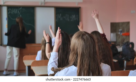 High school students stretch their hands in the lesson. Russian school. - Shutterstock ID 2227476663