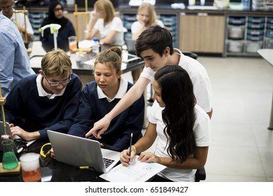 High School Students Studying In Chemistry Laboratory Experiment Class