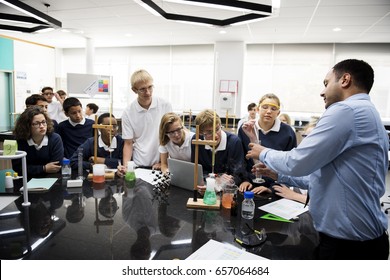 High School Students Studying In Chemistry Laboratory Experiment Class