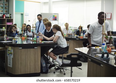 High School Students Studying In Chemistry Laboratory Experiment Class