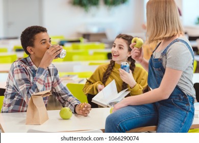 High School Students Taking Lunch Together At School Cafeteria