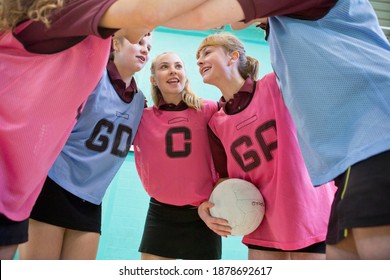 High School Students Talking In A Huddle Before A Netball Game.