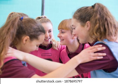 High School Students Talking In A Huddle Formation Before A Volleyball Game.