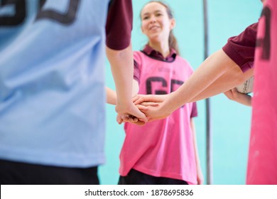 High School Students Touching Hands In A Huddle Before A Volleyball Game.