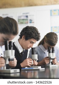 High School Students Using Microscopes In Laboratory