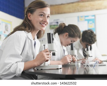 High school students using microscopes in laboratory - Powered by Shutterstock