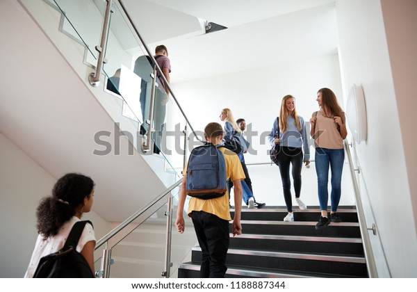 High School Students Walking On Stairs Between\
Lessons In Busy College\
Building