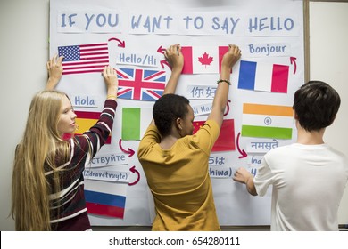 High School Students Working On International Flags Board