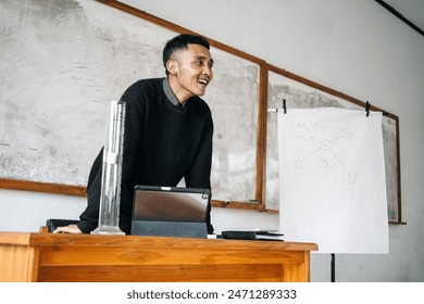 High School Teacher Standing In Front Of Interactive Whiteboard Teaching Lesson