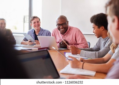 High School Teacher Talking To Pupils Using Digital Devices In Technology Class - Shutterstock ID 1126036232
