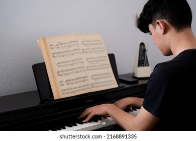 High School Teenager Playing The Piano.