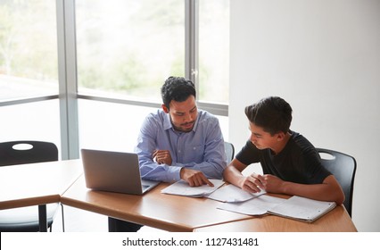 High School Tutor Giving Male Student With Laptop One To One Tuition At Desk - Shutterstock ID 1127431481