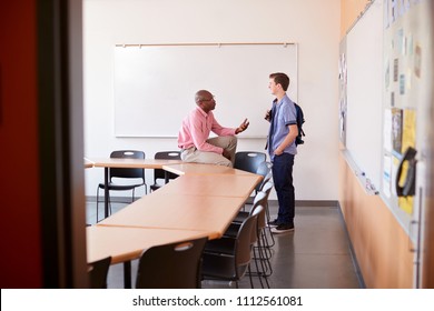 High School Tutor Talking With Male Student After Class