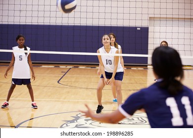 High School Volleyball Match In Gymnasium