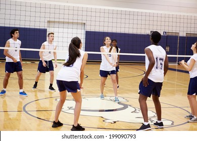 High School Volleyball Match In Gymnasium