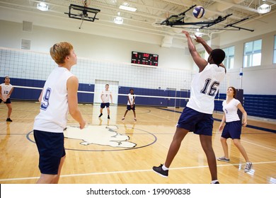 High School Volleyball Match In Gymnasium