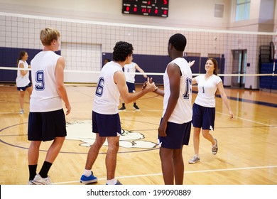 High School Volleyball Match In Gymnasium